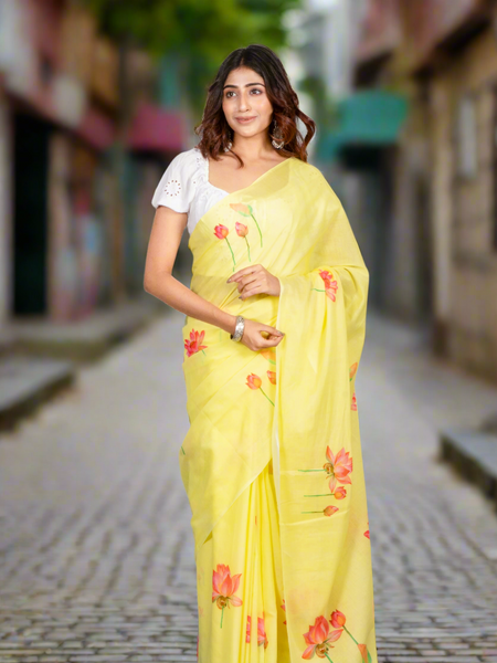 Woman wearing a yellow saree with floral patterns on a gray background