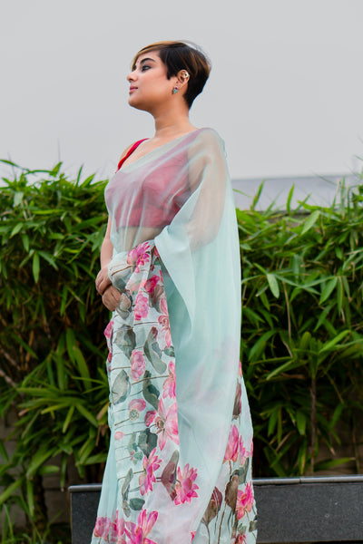 Woman wearing a floral saree with a light background