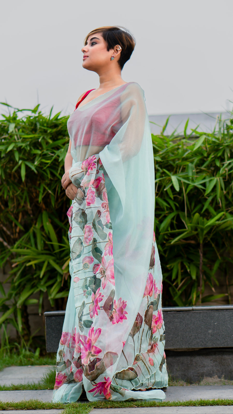 Woman wearing a floral saree with a light background